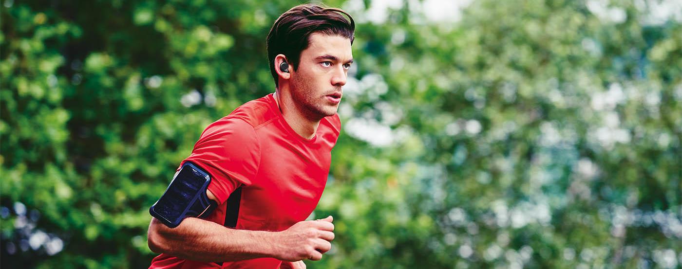 Man running, wearing Jabra Elite Sport.